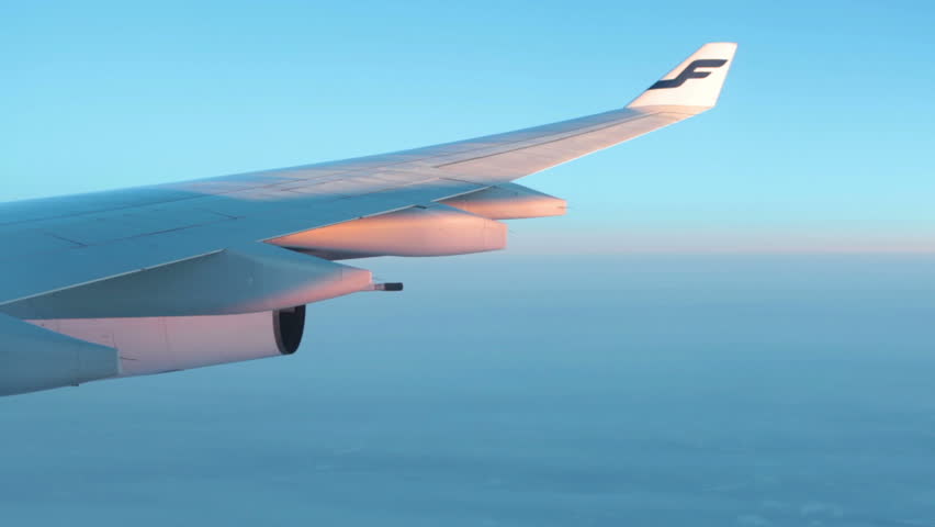 HELSINKI, FINLAND - CIRCA APRIL: Aircraft wing with sunlights playing on fuselage. Finnair logo on the tip on circa April, 2013 in Helsinki, Finland. Finnair is the largest airline of Finland