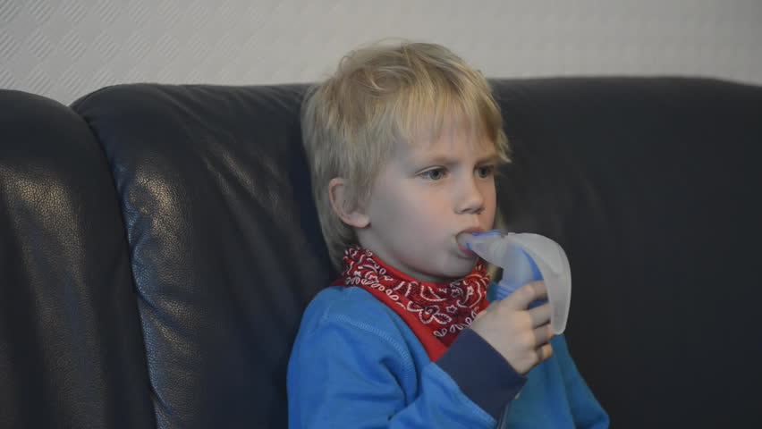 Boy using inhaler