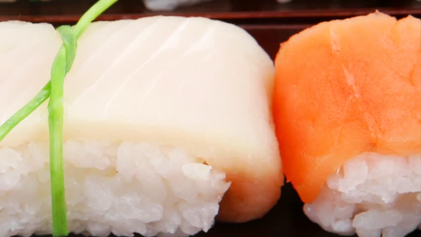 Japanese traditional cuisine - Different Types of Nigiri Sushi : Tuna (maguro) Salmon (sake) and Eel (unagi) with Wasabi and Ginger on bamboo mat 1920x1080 intro motion slow hidef hd