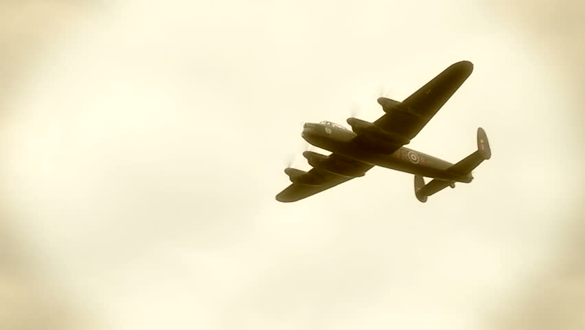 Avro Lancaster bomber plane from World War II flying.  Clip treated with various filters to resemble old film.  Originally recorded in slow motion at 60fps.
