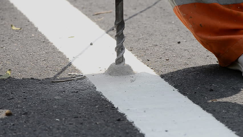 worker install stud solar on road