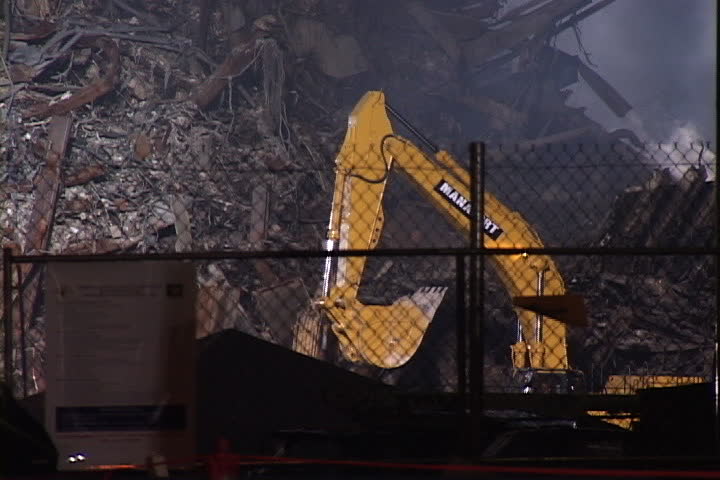 NEW YORK CITY - SEPTEMBER 28, 2001: Construction vehicle moves through pile of smoking World Trade Center rubble.
