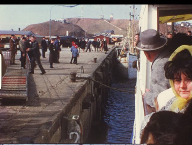 HELGOLAND, GERMANY - CIRCA 1970s: Group of people on boat take trip to Helgoland, Germany circa 1970s. Vintage 8mm film.