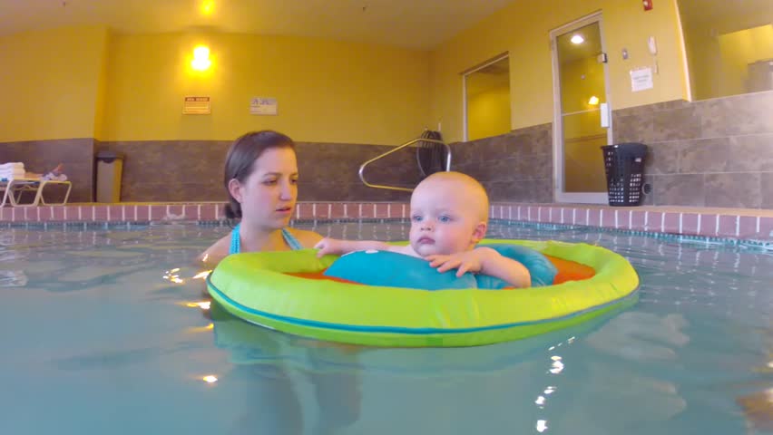 Underwater shot of a cute little baby boy at the swimming pool with his family.