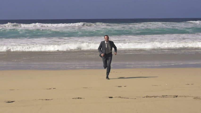 Businessman running on the beach, super slow motion, shot at 240fps

