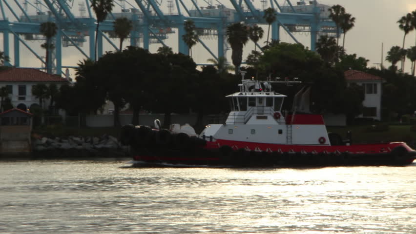 Tugboat makes it's way up the channel at sunrise - no logos.