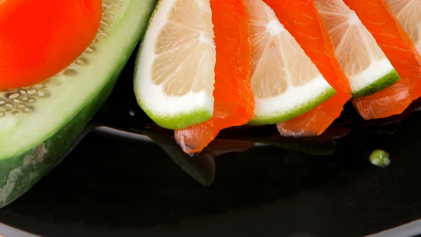 salmon slices and tomatoes on black plate 1920x1080 intro motion slow hidef hd
