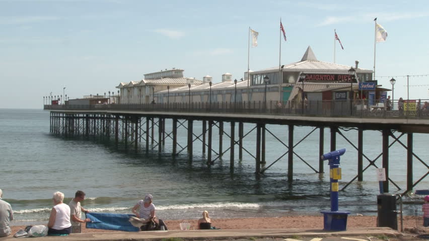 DEVON, UK - AUGUST 2012: A typical summer beach scene at Paignton Pier on the English Channel.