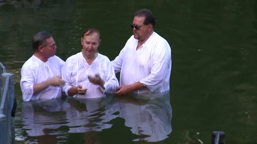 Jordan River, Israel - APRIL 22: Christian pilgrims to the holy land immerse themselves in the waters of Biblical Jordan River during a mass baptism ceremony April 22, 2009 in Jordan River, Israel.
