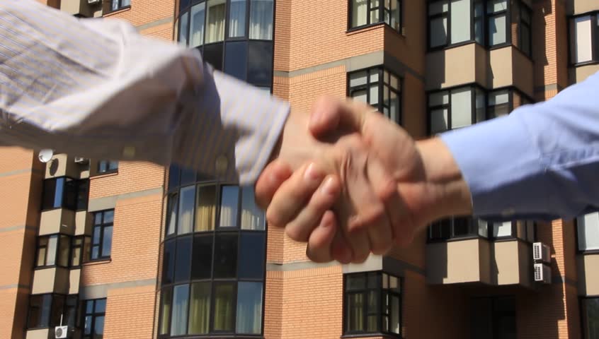 Business handshake. Two men shake hands. Two men in business suits shake hands