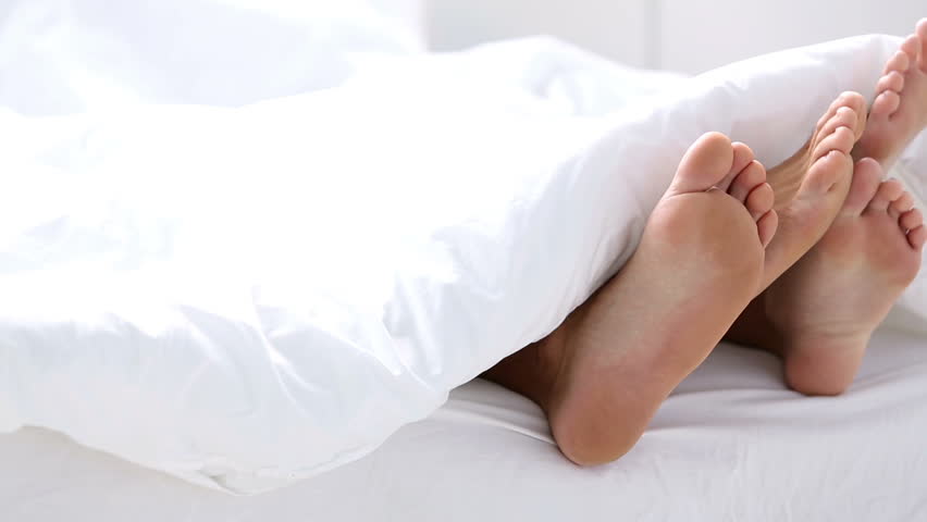 Pair Of Feet Under The Covers With One Wiggling Toes Stock Footage Video 4048615 Shutterstock