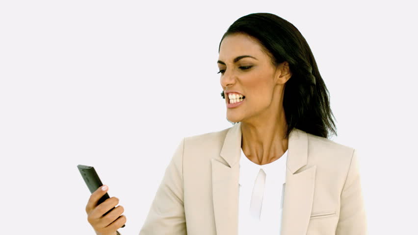 Businesswoman screaming down her mobile phone in slow motion