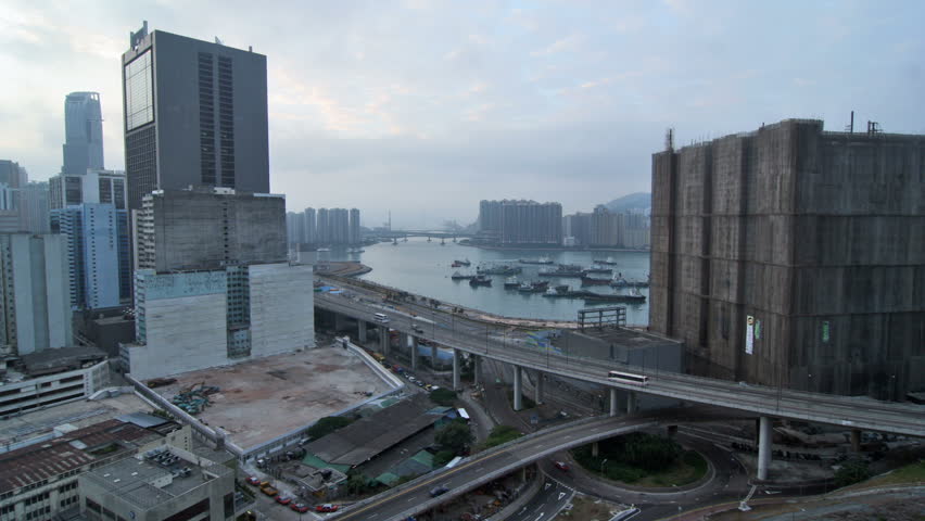 Hong Kong Cityscape Timelapse. Dawn of Tsuen Wan. Wide shot covering Rambler Channel between Tsing Yi and Kwai Chung with buildings at two sides. Busy traffic on highway and roundabout. 