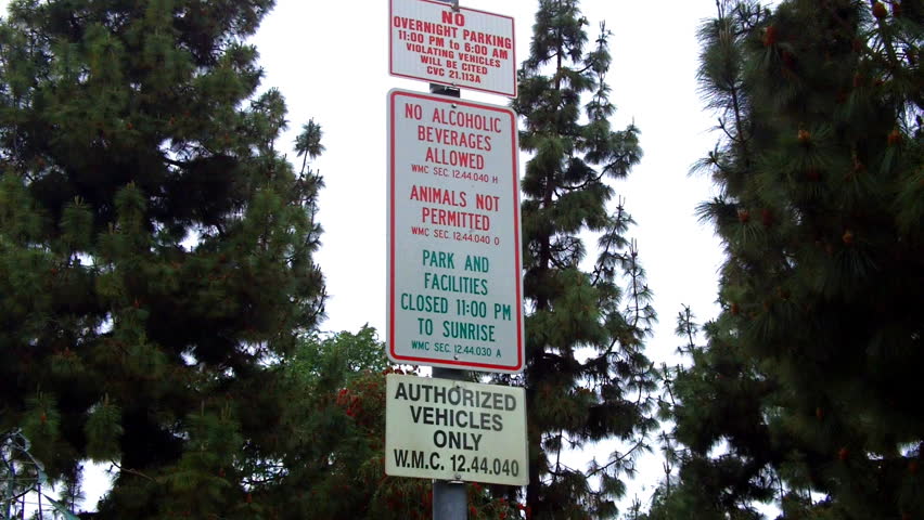 WHITTIER, CA: April 23 2013- Shot of a city park sign listing activities and restrictions circa 2013 in Whittier. This clip shows all the many rules one may encounter when trying to go to the park.