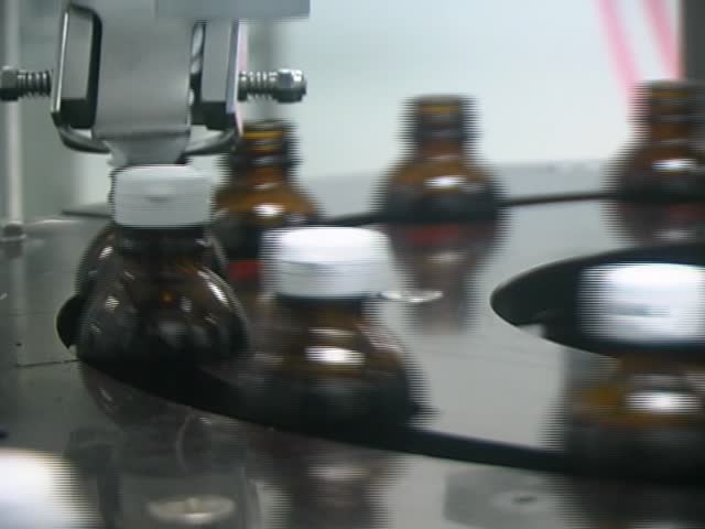 Close-up on a liquid medicine production line.
