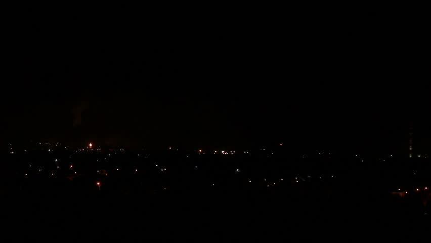 Lightning storm over city at night.