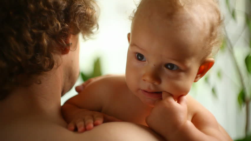 small child in a father's hands
