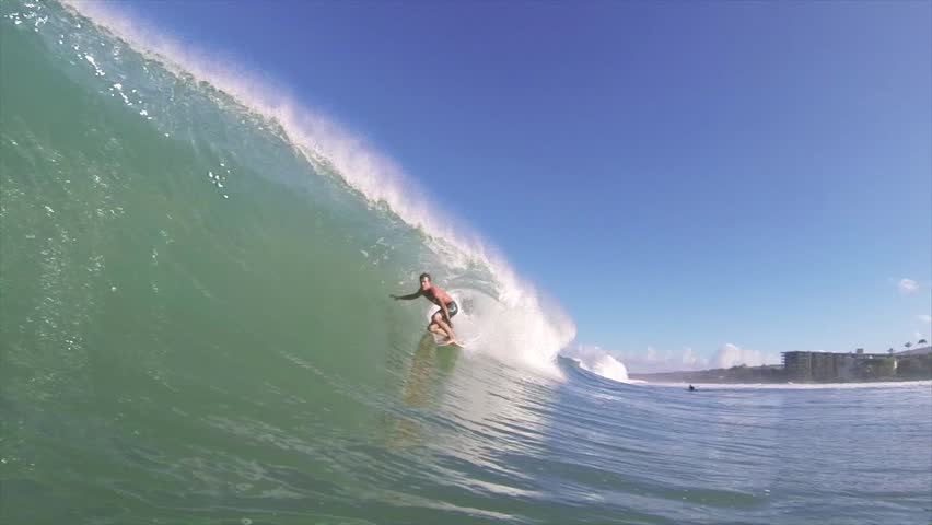 Surfer on Blue Ocean Wave Getting Barreled