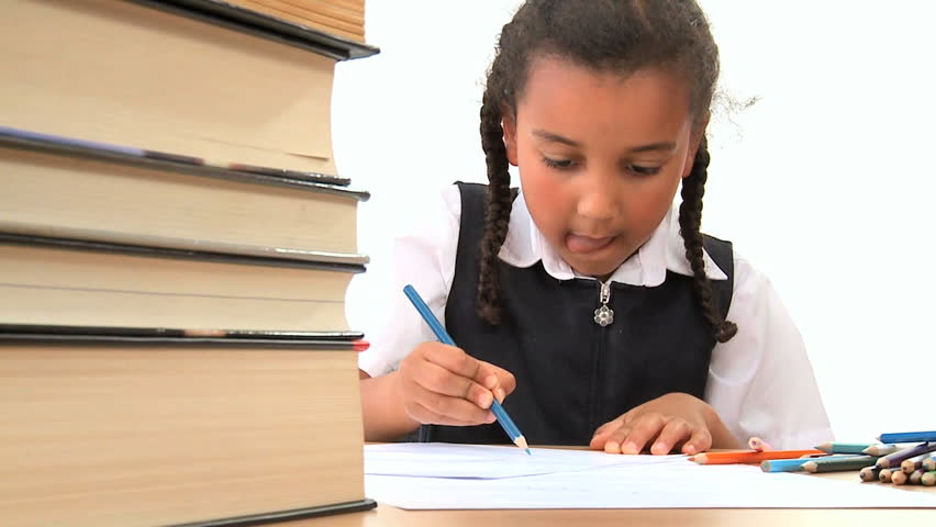 Cute african american schoolgirl early learning with colored crayons