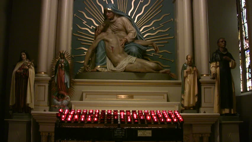 Video of crucified Jesus Christ and prayer candles in Catholic Cathedral San Antonio TX. Very decorative with colors, gold and windows. Christian belief. Don Despain Rekindle Photo