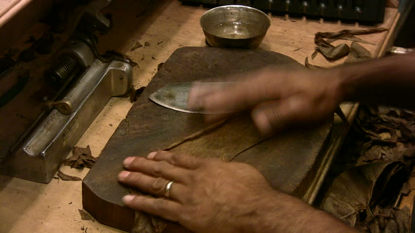 Video man rolling handmade cigars left to right.  Roll and cut. Fine hi quality smoke. Custom Aficionado tobacco humidors cigar shop San Antonio, Texas. Don Despain of Rekindle Photo