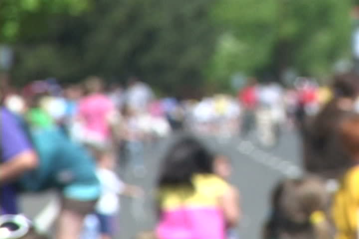 Background of many people gathered together with soft focus, unrecognizable people,  large and small.