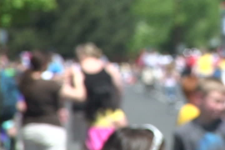 Background of many people gathered together with soft focus, unrecognizable people,  large and small.