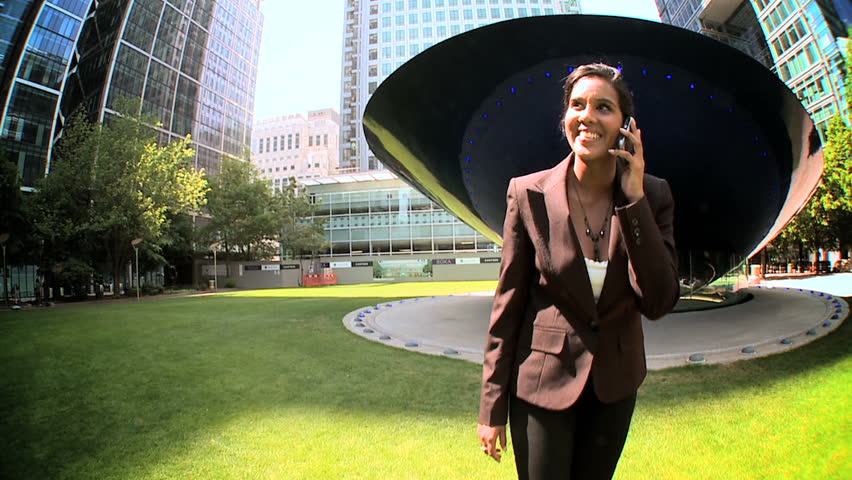 Steadicam with smart city business woman using a mobile(cell) phone