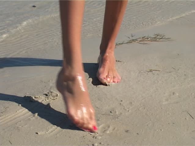 Woman Washes Her Feet From Sand Under Water Stream On Be