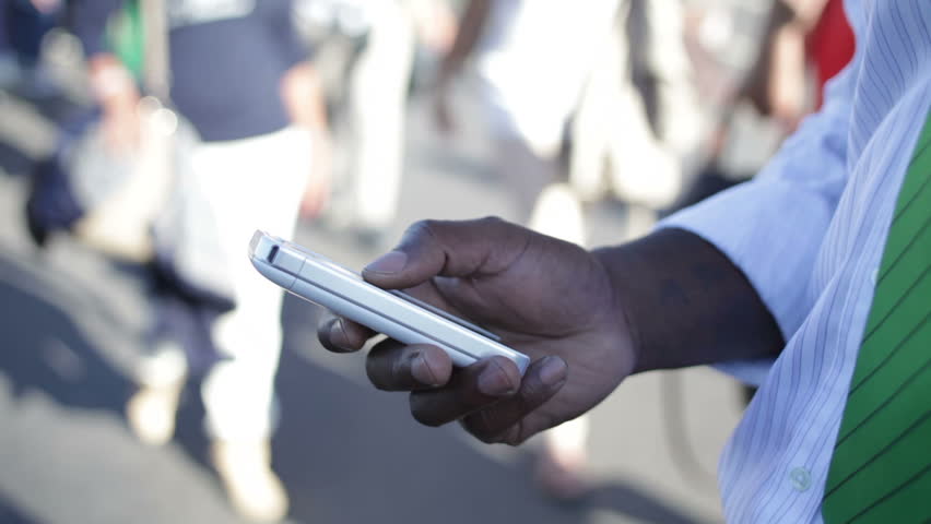 Businessman using his phone on London street 