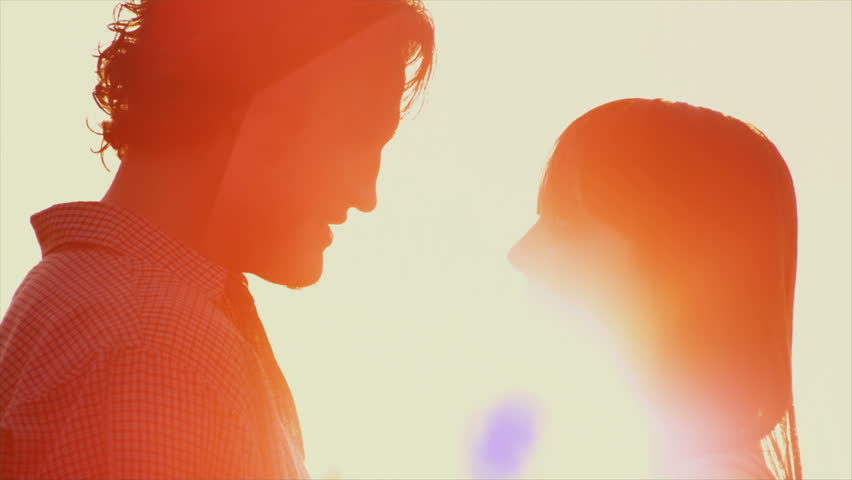 Beautiful Young Couple in Love kiss in the sun