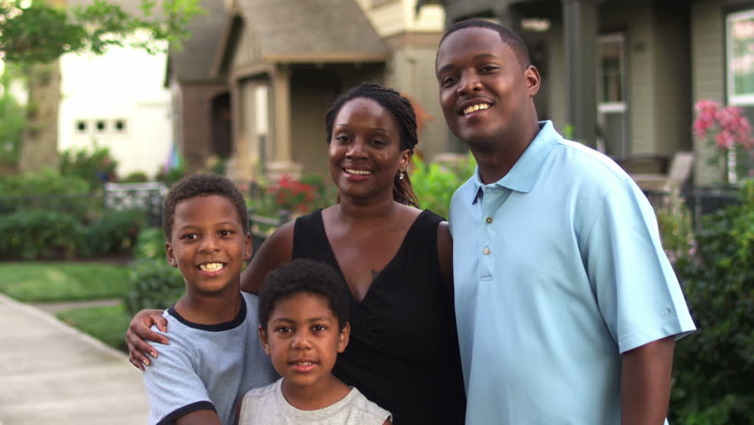 African American Family Walk Down Neighborhood Together. Wide Dolly