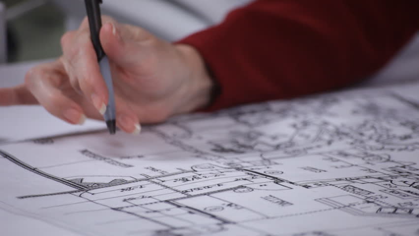 An ethusiastic designer talking to someone off camera about the layout she has created.