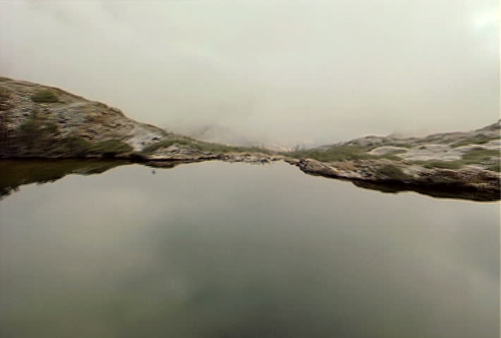 Flying over a pair of small lakes, high in the misty Sierra Nevada Mountain Range.
