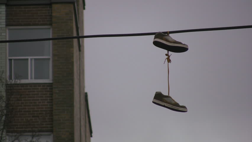 Sneakers hanging from wire.
