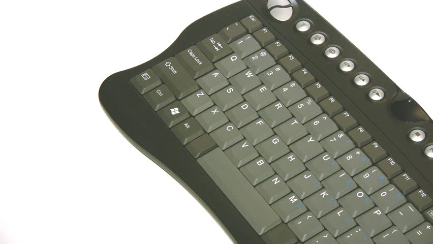 Circling around a black compact keyboard, isolated on white.