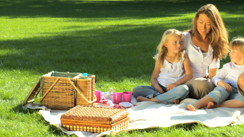 Young caucasian family enjoying time out together with a picnic on a summers day