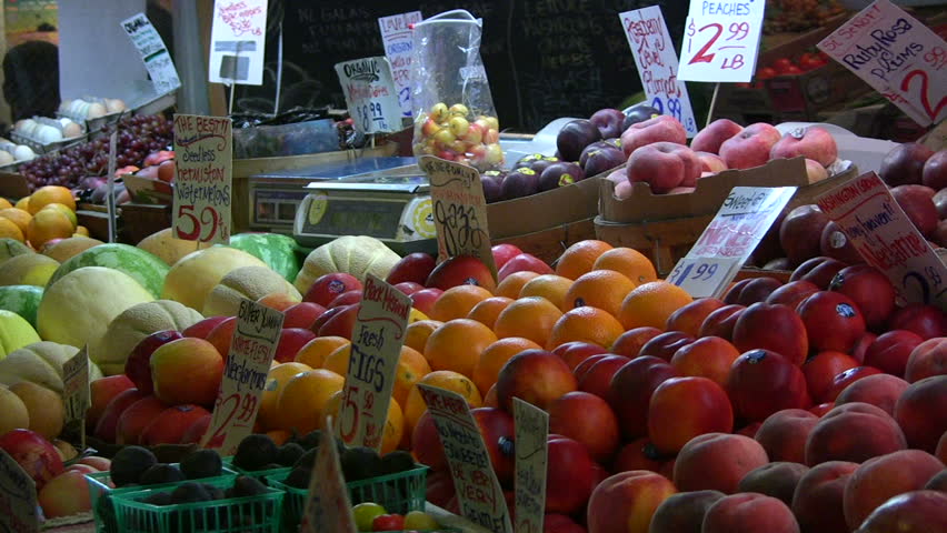 Money transaction taking place at a colorful market. HD 1080i
