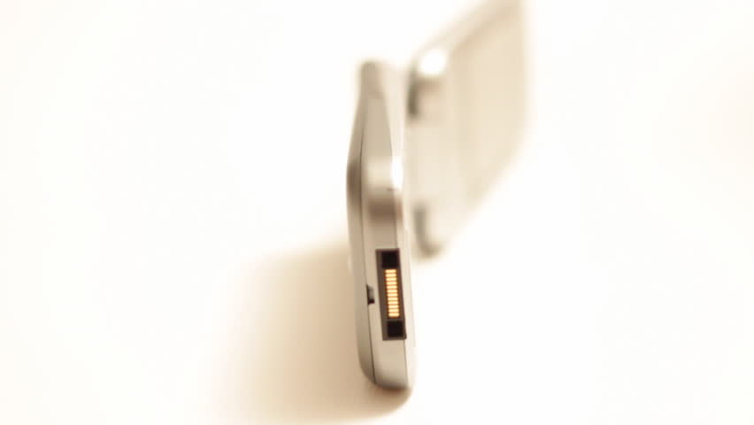 A rotating clam shell cellular phone, with shallow depth of focus, isolated on white.