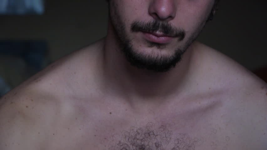 a naked young White man smoke cigarette toward camera