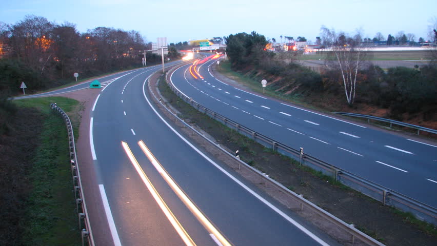 HD time lapse, sunset over cars lights on highway