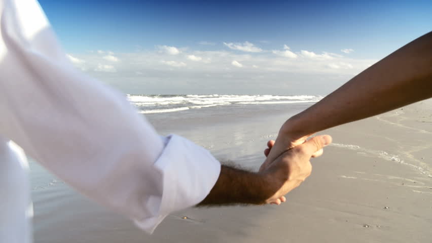Two young people in love walking on the beach early morning after a social night out 60 FPS 