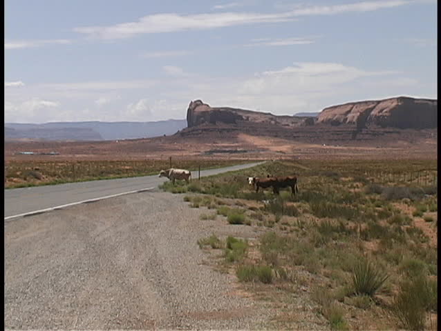 A small dust storm, known as a "dust devil" blows up in the distance in Monument Valley on the Navajo Reservation.
