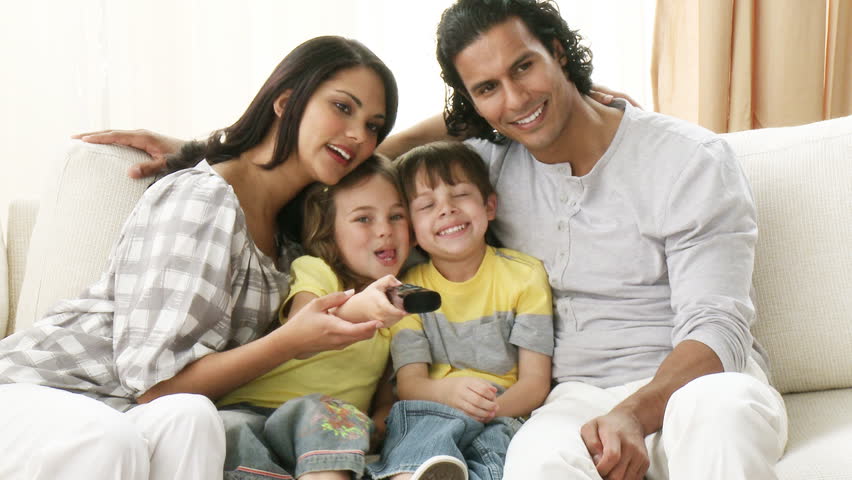 Footage in high definition of family on the sofa watching television