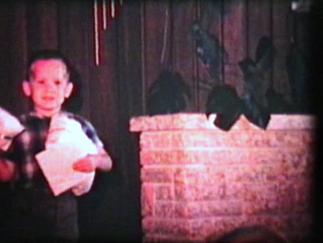 A cute little girl is not interested in opening her birthday presents but is distracted by her older brother. (Vintage 8mm film)