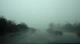 Rainy Day on the freeway through windshield wipers