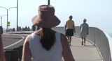 People walking along Carlsbad California boardwalk