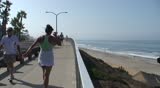 People walking on a boardwalk in Carlsbad, California