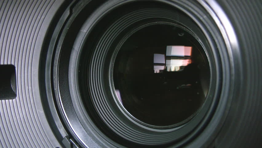 Camera zoom. Closeup shot of professional video camera, with its lens zooming in and out. Canon XH-A1s shot with a Canon HV30. 
