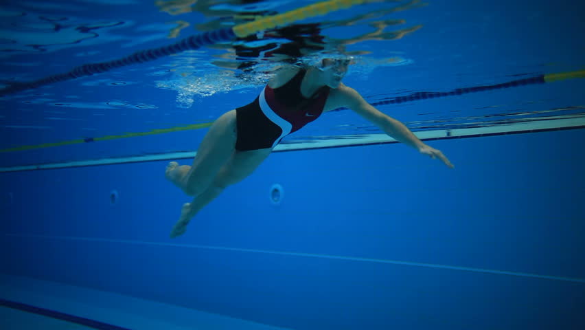 Underwater picture of a young woman swimming.